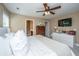Bright main bedroom featuring a ceiling fan, dresser, television and a doorway to the en suite bathroom at 286 Chemistry Cir, Ladson, SC 29456