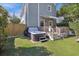 Inviting backyard featuring a hot tub, wooden deck with awning, and a lush green lawn at 29 Bogard St, Charleston, SC 29403