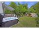 The backyard features a hot tub, lounge area, lush lawn, and beautiful landscaping at 29 Bogard St, Charleston, SC 29403