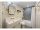 Stylish bathroom with designer wallpaper and decorative blue tile in shower and on floor at 29 Bogard St, Charleston, SC 29403