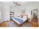 Bright bedroom with hardwood floors, a ceiling fan, and stylish decor at 29 Bogard St, Charleston, SC 29403
