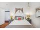 Inviting bedroom featuring a wicker bed frame and white walls at 29 Bogard St, Charleston, SC 29403