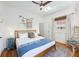 Cozy bedroom featuring a wooden bed frame, colorful bedside table, and unique artwork at 29 Bogard St, Charleston, SC 29403
