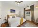 Comfortable bedroom with queen bed, ceiling fan, art, and window with views at 29 Bogard St, Charleston, SC 29403
