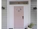 Charming pink front door with a decorative window and smart lock at 29 Bogard St, Charleston, SC 29403
