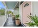 Inviting front porch with a cozy seating area and stylish potted plants, perfect for relaxing outdoors at 29 Bogard St, Charleston, SC 29403