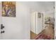 Hallway with hardwood floors leads to a kitchen; decorated with artwork, it invites exploration at 29 Bogard St, Charleston, SC 29403
