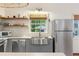 Modern kitchen with stainless steel appliances, subway tile backsplash, and floating shelves at 29 Bogard St, Charleston, SC 29403