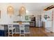 Open kitchen with seating at the bar, stainless steel appliances, open shelves, and a washer-dryer at 29 Bogard St, Charleston, SC 29403