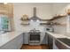 Bright kitchen features stainless steel appliances, white subway tile, and floating wood shelves at 29 Bogard St, Charleston, SC 29403