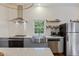 Farmhouse kitchen features stainless steel appliances, window, and sleek countertops at 29 Bogard St, Charleston, SC 29403