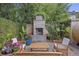 Cozy outdoor fireplace area surrounded by lush plants and comfortable seating at 29 Bogard St, Charleston, SC 29403