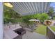Outdoor patio with comfortable seating, retractable awning, and lush greenery at 29 Bogard St, Charleston, SC 29403