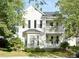 Charming two-story home with double balconies, a manicured lawn, and mature trees at 30 Regency Oaks Dr, Summerville, SC 29485