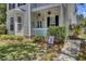 Inviting porch with turquoise door, white railing, and lush landscaping at 30 Regency Oaks Dr, Summerville, SC 29485