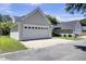 Spacious two car garage with white doors, nice landscaping, and long driveway for parking convenience at 30 Regency Oaks Dr, Summerville, SC 29485