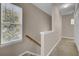 Upstairs hallway featuring neutral colors and a sun-drenched window at 30 Regency Oaks Dr, Summerville, SC 29485