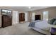 Bright main bedroom featuring a ceiling fan, ensuite bathroom, and balcony access at 30 Regency Oaks Dr, Summerville, SC 29485