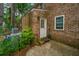 Brick home featuring a back entrance, leading to a concrete patio and providing convenient access to the outdoors at 306 Crestview Dr # C, Summerville, SC 29485
