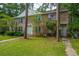 Charming brick townhouse with a well-maintained lawn and mature trees providing shade at 306 Crestview Dr # C, Summerville, SC 29485