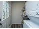 Functional laundry area with a stacked washer and dryer unit and convenient shelving at 306 Crestview Dr # C, Summerville, SC 29485