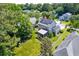 An aerial view of the home showcasing solar panels, screened porch, spacious yard, and lush greenery at 3073 Penny Ln, Johns Island, SC 29455