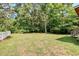 Spacious backyard with lush greenery and a wood fence at 3073 Penny Ln, Johns Island, SC 29455