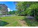 Expansive backyard with lush lawn and mature trees, perfect for outdoor activities at 3073 Penny Ln, Johns Island, SC 29455
