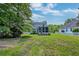 A large, grassy backyard featuring the screened porch and solar panels at 3073 Penny Ln, Johns Island, SC 29455