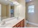 Bathroom featuring double sinks, a large mirror, and a combination shower and tub at 3073 Penny Ln, Johns Island, SC 29455