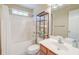 This bathroom features a shower/tub combo with white tile and a storage rack at 3073 Penny Ln, Johns Island, SC 29455