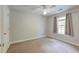 Bright bedroom with neutral carpet, ceiling fan and natural light from the window at 3073 Penny Ln, Johns Island, SC 29455