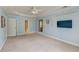 Large bedroom featuring a neutral carpet, tray ceilings, and a door to the adjoining bathroom at 3073 Penny Ln, Johns Island, SC 29455