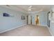 Open bedroom with soft blue walls, neutral carpet, and a glimpse of the en-suite bathroom at 3073 Penny Ln, Johns Island, SC 29455