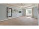 A spacious bedroom with tray ceilings, neutral carpet, and a large window with natural light at 3073 Penny Ln, Johns Island, SC 29455