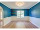 Bright dining room with a large window, elegant lighting, and stylish blue and white walls at 3073 Penny Ln, Johns Island, SC 29455