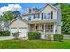 Charming two-story home features a welcoming front porch and well-maintained landscaping at 3073 Penny Ln, Johns Island, SC 29455