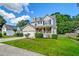 Charming two-story home featuring a well-manicured lawn, attached two-car garage, and a welcoming front porch at 3073 Penny Ln, Johns Island, SC 29455