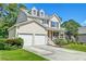Charming home featuring a well-manicured lawn, two car garage, and covered front porch at 3073 Penny Ln, Johns Island, SC 29455