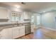 The kitchen features granite counters, a stainless steel dishwasher, a double sink, and access to the back deck at 3073 Penny Ln, Johns Island, SC 29455