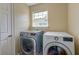 Bright laundry room with side-by-side washer and dryer and window at 3073 Penny Ln, Johns Island, SC 29455