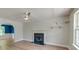 Cozy living room with hardwood floors, a fireplace, and a window offering natural light at 3073 Penny Ln, Johns Island, SC 29455