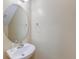 Cozy powder room featuring a stylish oval mirror and a pedestal sink at 3073 Penny Ln, Johns Island, SC 29455