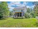 Home featuring solar panels, a screened porch, and a lush backyard, blending sustainability with outdoor living at 3073 Penny Ln, Johns Island, SC 29455