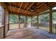 Large screened porch with a ceiling fan and wood flooring at 3073 Penny Ln, Johns Island, SC 29455