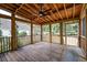 Spacious screened porch with wood flooring and ceiling fan, perfect for outdoor relaxation at 3073 Penny Ln, Johns Island, SC 29455