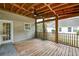 Covered screened porch with wooden floor, ceiling fan and view of the backyard at 3073 Penny Ln, Johns Island, SC 29455