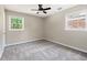 Bedroom with two windows, carpet flooring, and ceiling fan at 315 Elliott Dr, Ladson, SC 29456