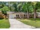 Quaint brick home with well-kept lawn, a driveway, and a welcoming entrance with chairs at 315 Elliott Dr, Ladson, SC 29456