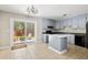 Eat in kitchen with an island, sliding glass door access to the outdoor patio and backyard at 315 Elliott Dr, Ladson, SC 29456